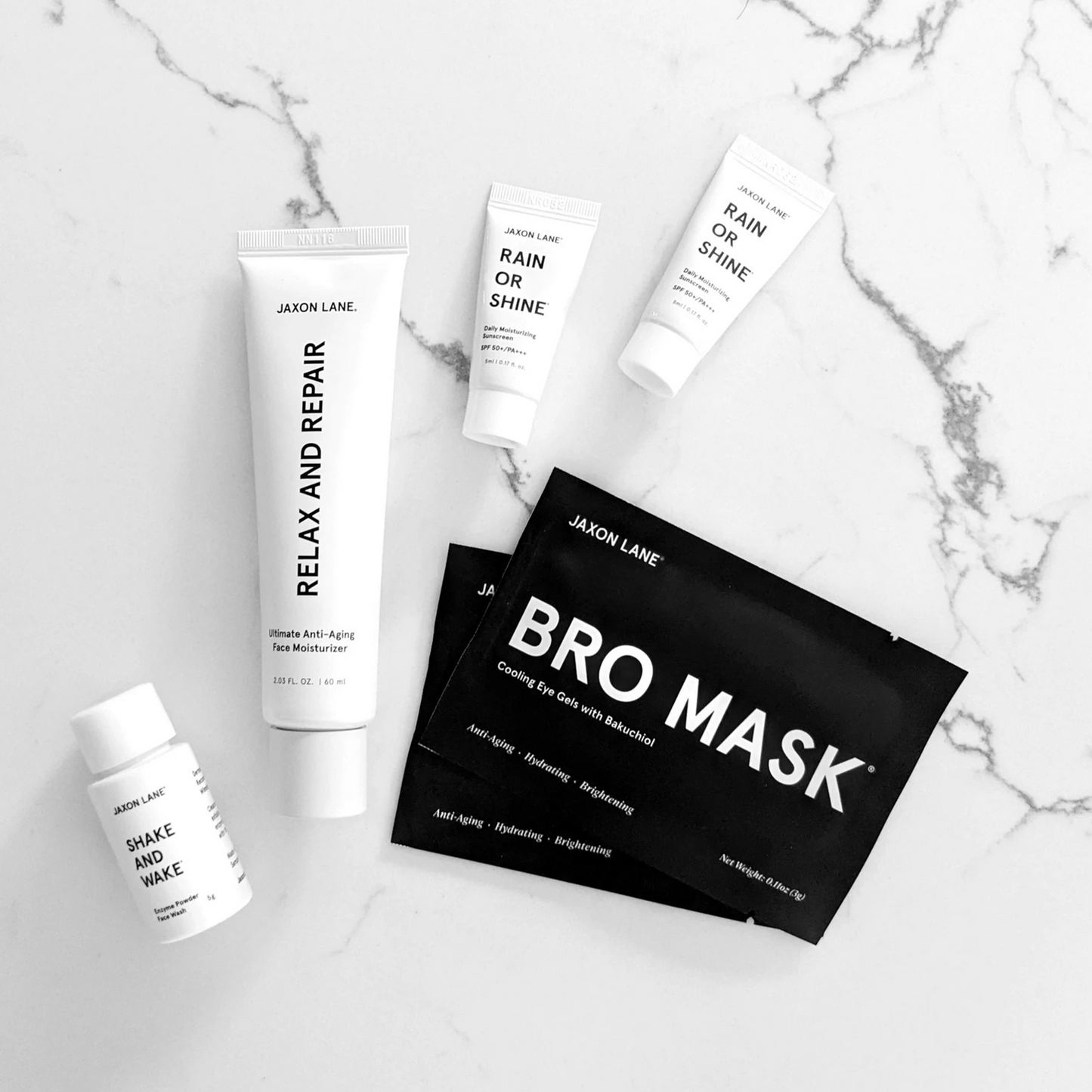 Jaxon Lane Travel Skincare Set: Look amazing, wherever life may take you. Bro Mask Eye Gels (2 pairs) Ultimate Anti-Aging Moisturizer (Full Size - 60 ml) Enzyme Powder Face Wash (Travel Mini - 5 g) 2x Sunscreen (Travel Mini - 2x 5 ml) Waterproof Travel Pouch