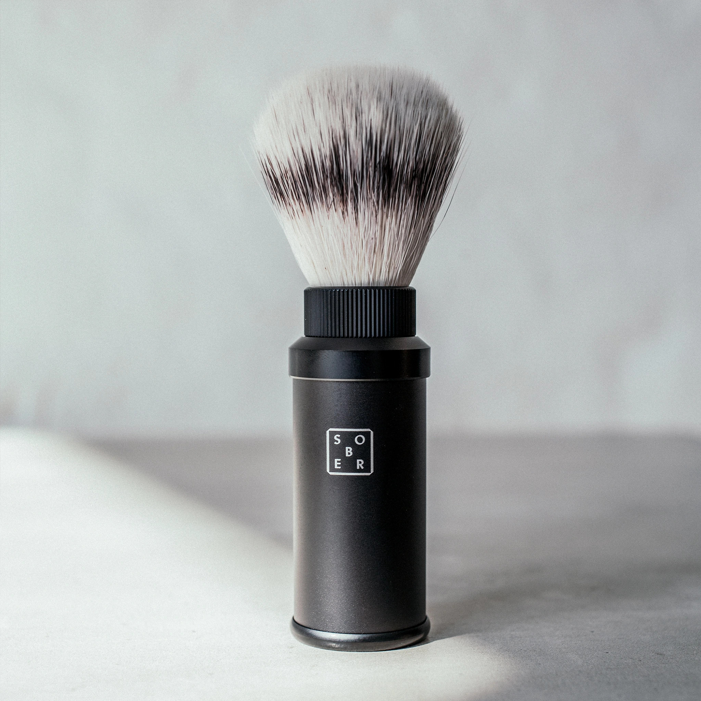 Sober Shaving Brush: Ready for a great shaving experience anytime, even when travelling? The sober shaving brush made of light and stable aluminum and soft bristles that are superior in use is the perfect tool to achieve a foaming effect on the shaving cream and to raise the whiskers so that the blade can glide evenly over the skin. The 3-part aluminum shaving brush consists of an aluminum casing with a matt black coating, in which the brush can be completely submerged after use if required.