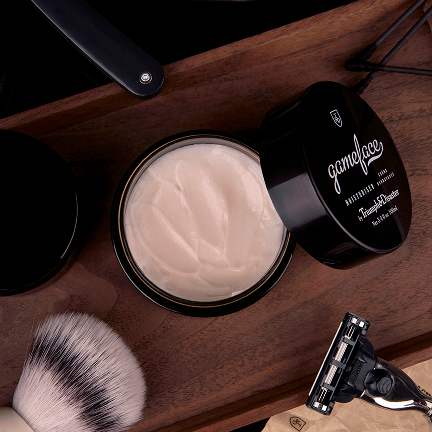 Triumph and Disaster Gameface Moisturiser - Jar: Gameface moisturizer is a tool to serve and protect you against the elements. Specifically engineered to be light on the skin and easily absorbed, Gameface is a unique formulation of Jojoba extract, Horopito oil, Ponga fern (Cumingii) and Vitamin E, combined with a subtle infusion of essential oils to deliver a fragrance we call 'smoke and wood'. The result is a nutrient rich, hydrating cream that will leave skin feeling toned, supple and fresh.